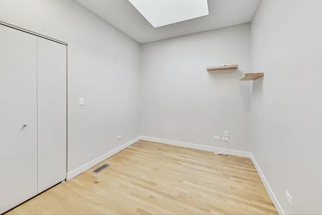 a view of a hallway with wooden floor and entryway