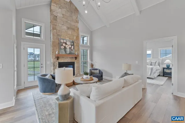 a living room with fireplace furniture and a wooden floor