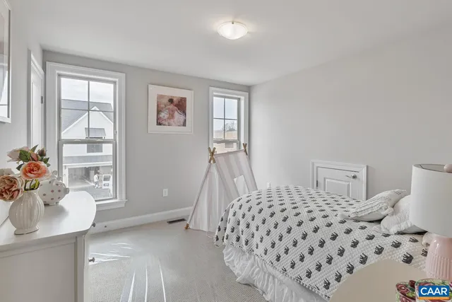 a bedroom with a bed and a lamp