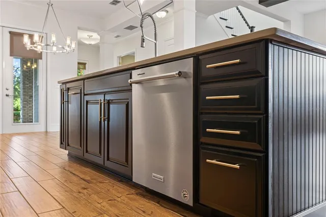 a bathroom with a granite countertop sink a mirror and shower