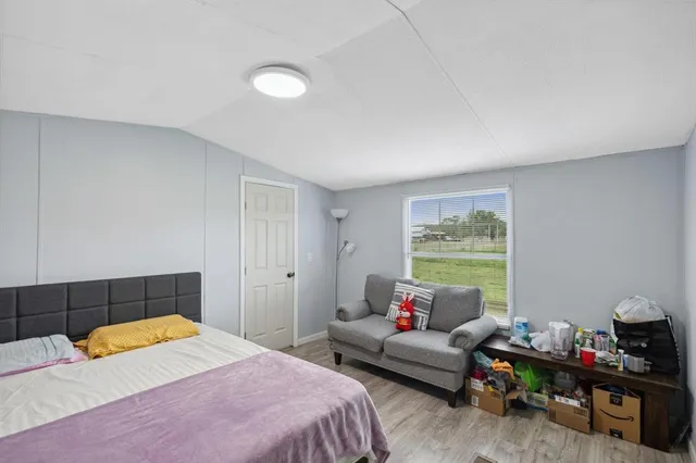 a bedroom with furniture and a window