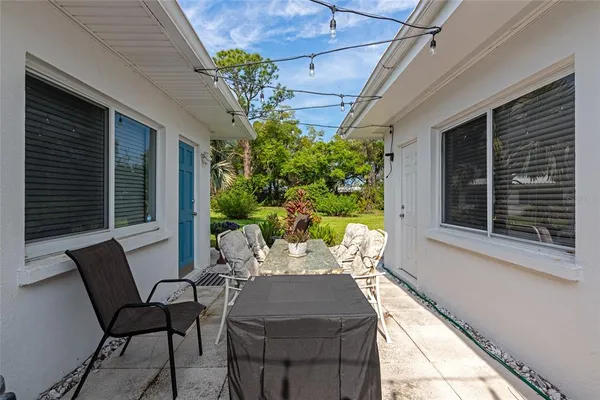 a view of a patio with table and chairs and potted plants