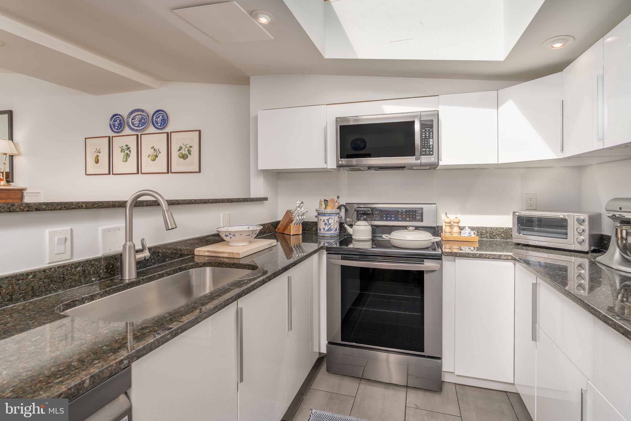 2115 S Street Northwest, Unit 3A Washington, DC 20008 - Photo 11 of 26 a kitchen with stainless steel appliances granite countertop a sink and a stove