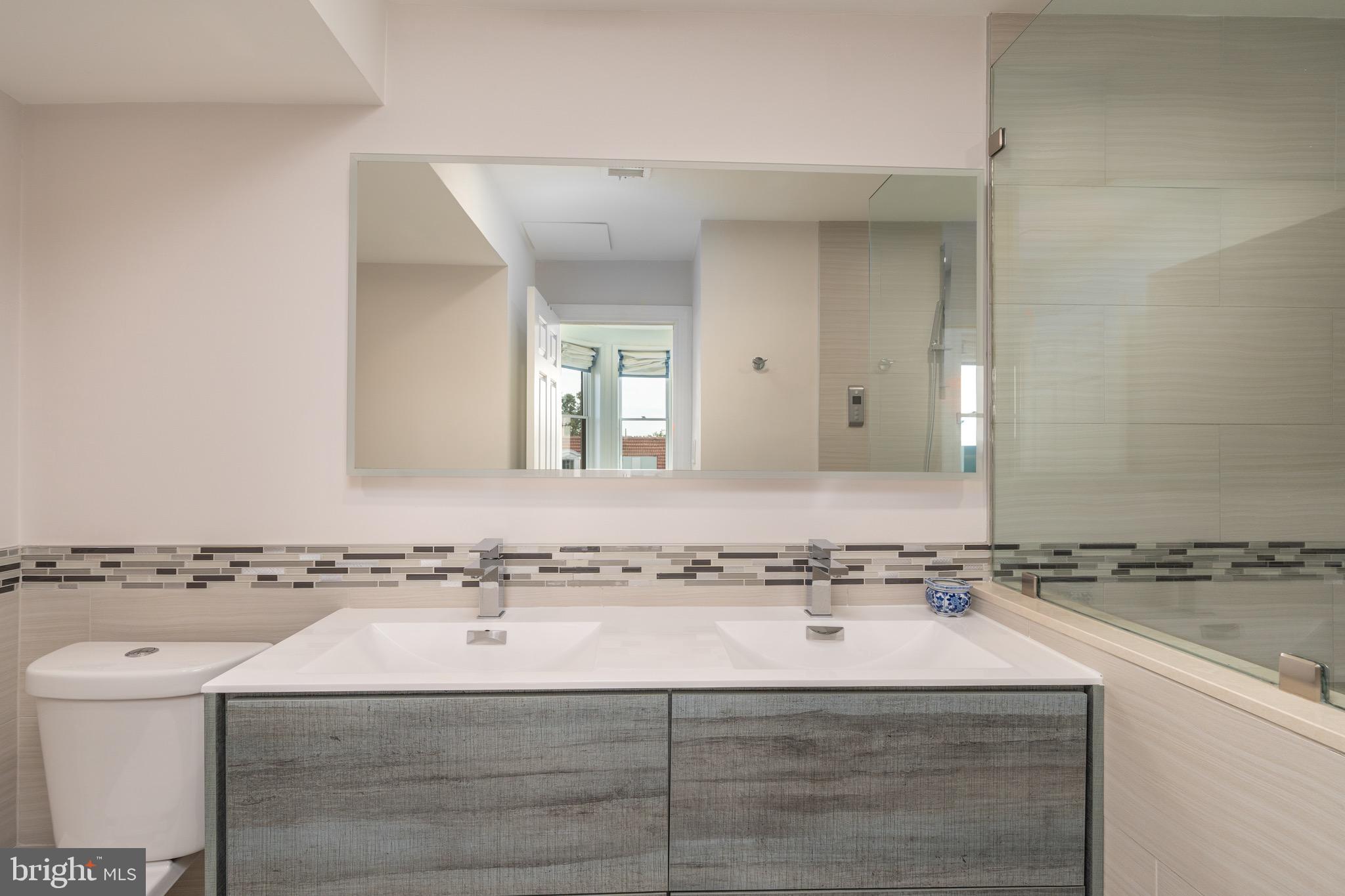 2115 S Street Northwest, Unit 3A Washington, DC 20008 - Photo 22 of 26 a bathroom with a sink and a mirror