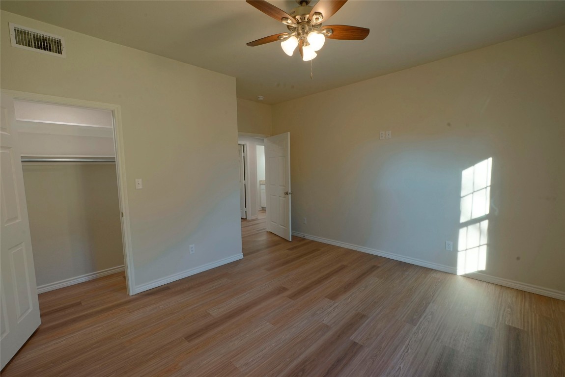 233 Harrison Street Longview, TX 75601 - Photo 15 of 24 a view of an empty room with wooden floor and a window