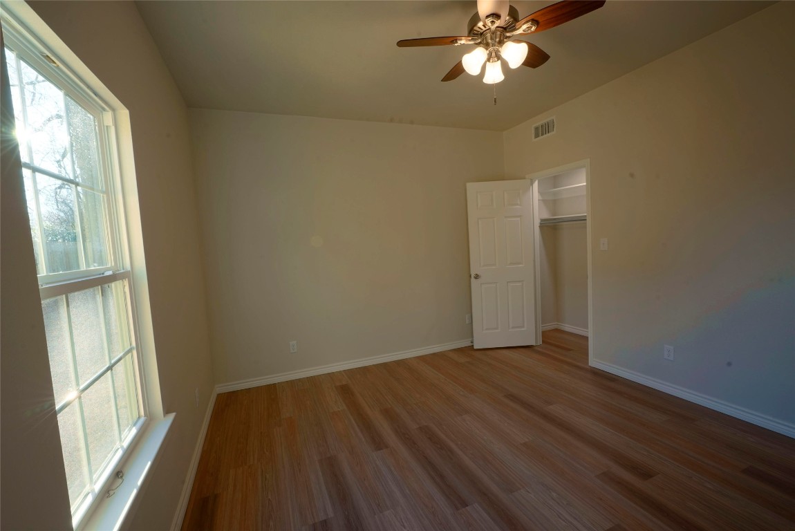 233 Harrison Street Longview, TX 75601 - Photo 16 of 24 a view of empty room with wooden floor and fan