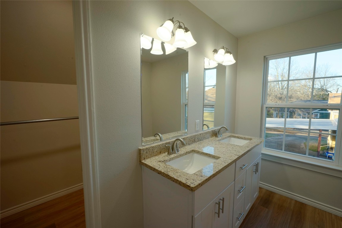 233 Harrison Street Longview, TX 75601 - Photo 20 of 24 a bathroom with a sink and a mirror