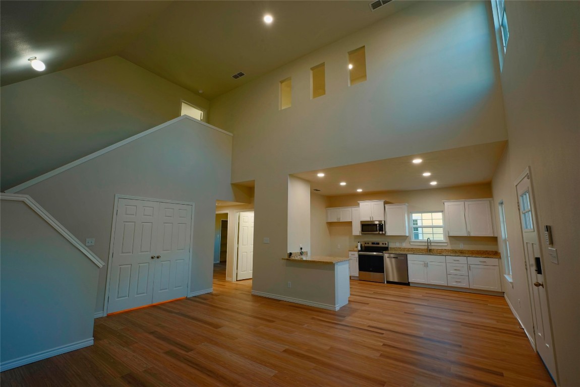 233 Harrison Street Longview, TX 75601 - Photo 3 of 24 a view of kitchen with kitchen island wooden floor center island and stainless steel appliances