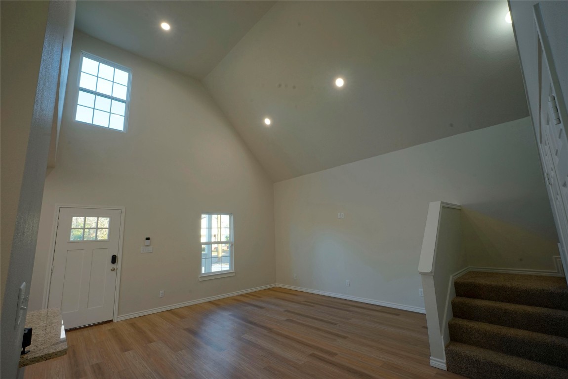 233 Harrison Street Longview, TX 75601 - Photo 5 of 24 an empty room with wooden floor and windows