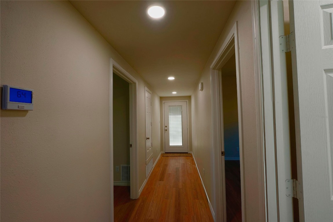 233 Harrison Street Longview, TX 75601 - Photo 9 of 24 a view of a hallway with wooden floor