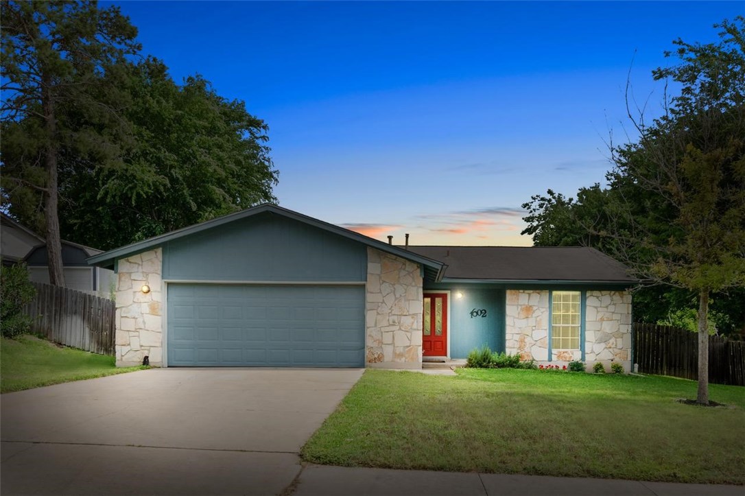 1602 Old Tract Road Pflugerville, TX 78660 - Photo 1 of 1 a front view of a house with a garden and trees