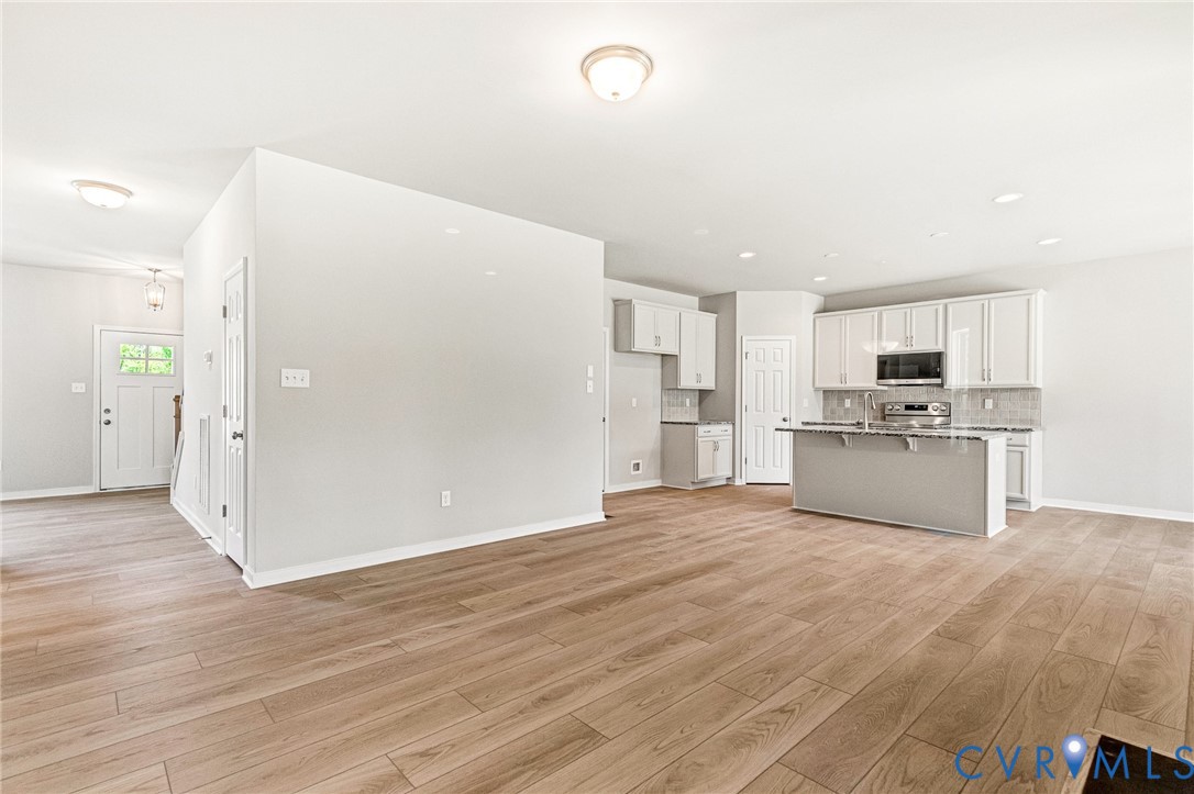 10010 Cool Spring Road Mechanicsville, VA 23116 - Photo 6 of 13 Expansive open-concept living area featuring wood-