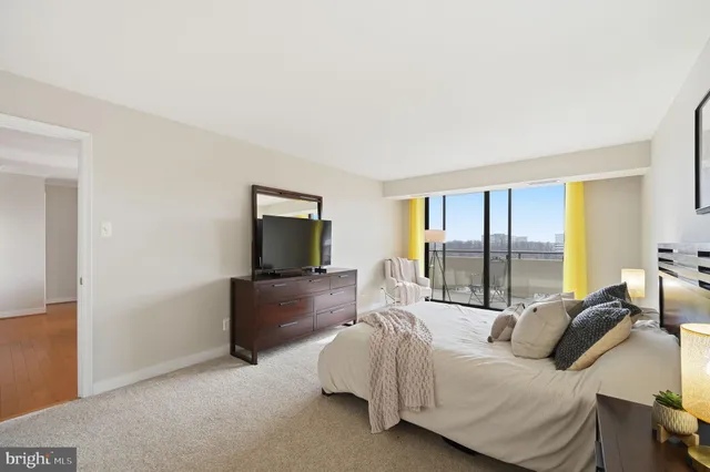 a bedroom with a bed and large window