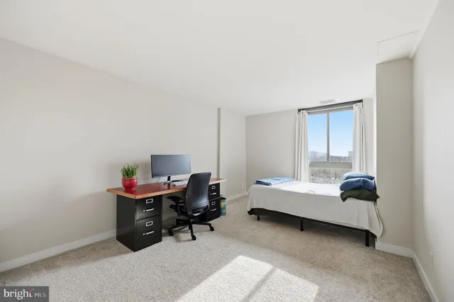 a bedroom with a workspace