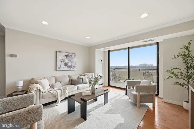 a living room with furniture and a large window with outer view