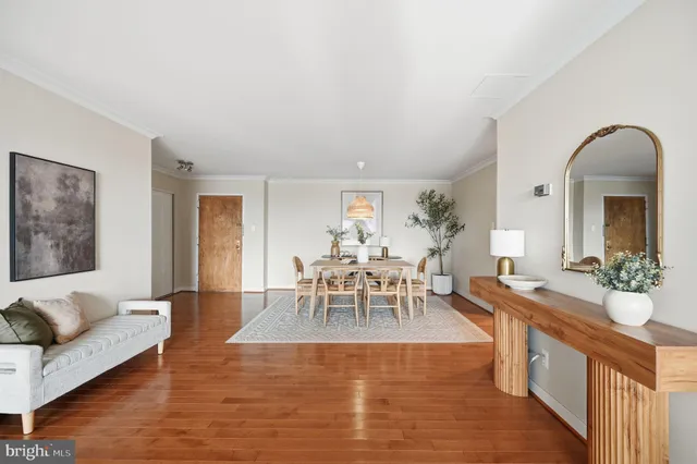 a living room with furniture dining table and a large window