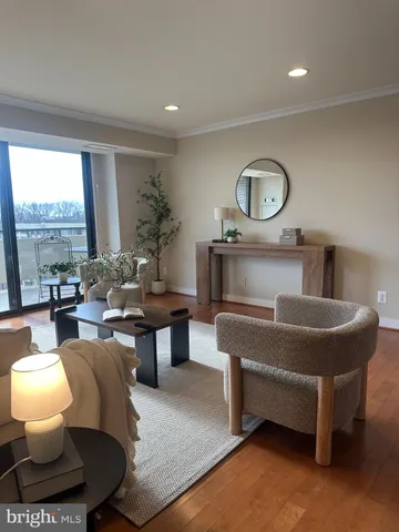 a living room with furniture a window and a table