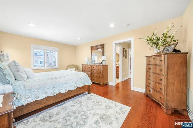 a bedroom with furniture and wooden floor