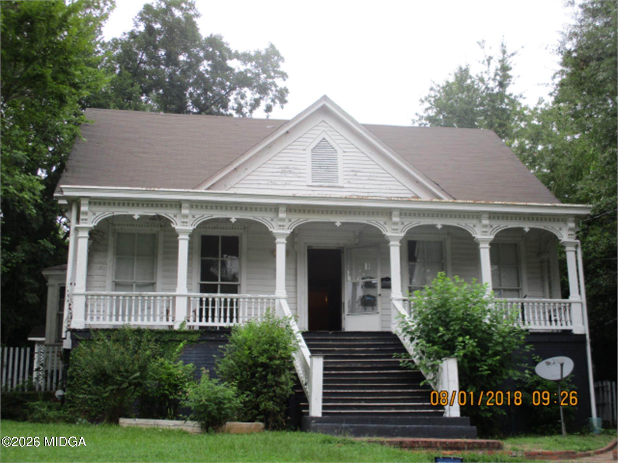 991 Magnolia Street, Unit 3 Macon, GA 31201 - Photo 1 of 1 a view of a white house with potted plants and large windows