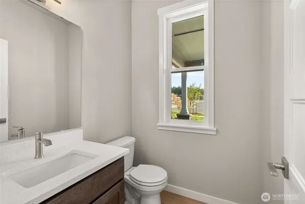 a bathroom with a sink a toilet and a window