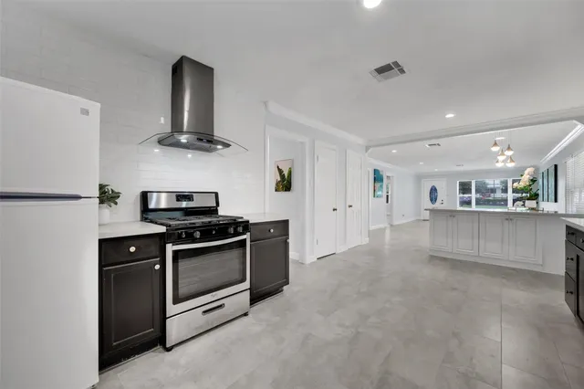 a kitchen with stainless steel appliances granite countertop a sink and a stove top oven