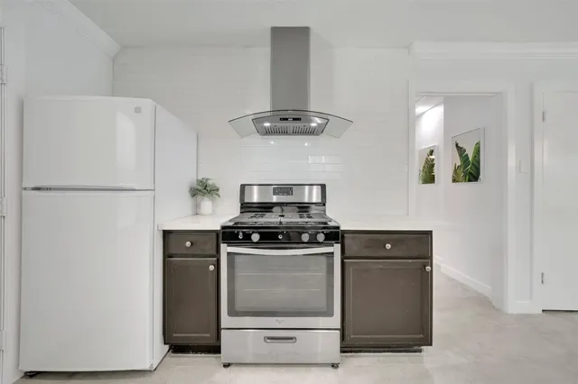 a kitchen with a stove and a refrigerator