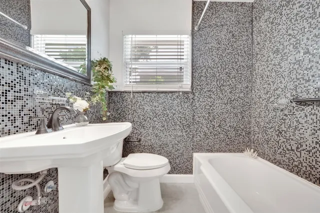 a bathroom with a sink a toilet and a bathtub