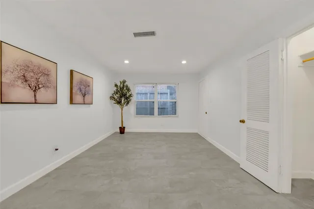 a view of a big room with window and stairs
