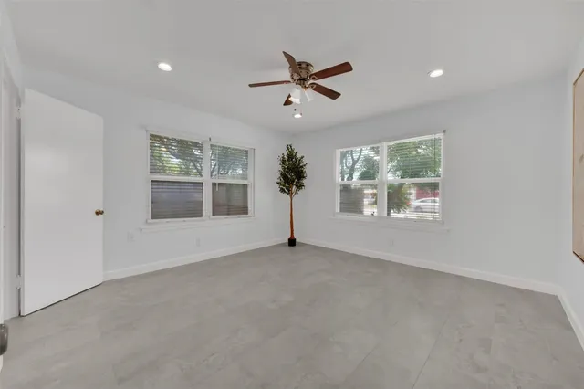 a view of a livingroom with a ceiling fan and window