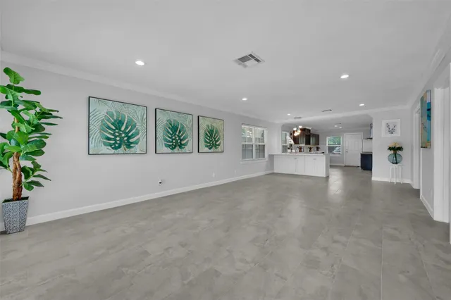 an empty room with furniture and a potted plant