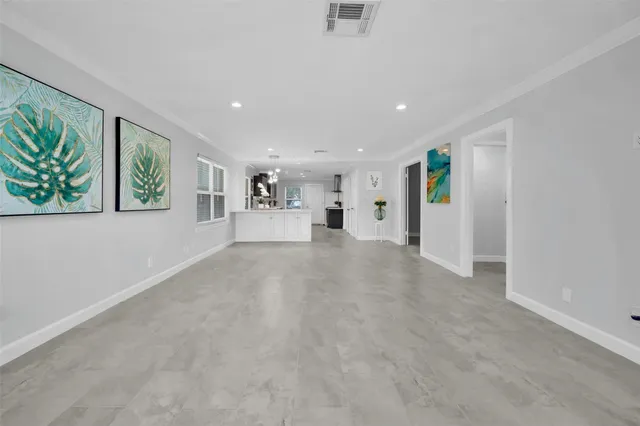 a view of a livingroom with wooden floor and window