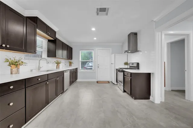 a kitchen with cabinets and window