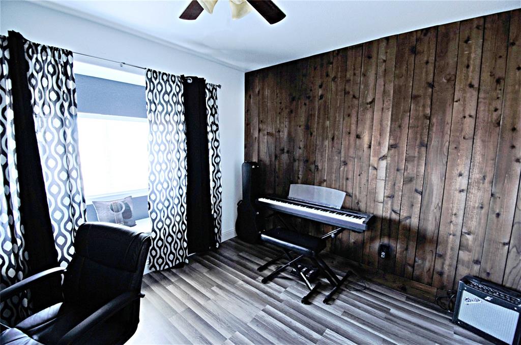 3702 Dogwood Road Melissa, TX 75454 - Photo 14 of 24 a view of a balcony with chair and wooden floor