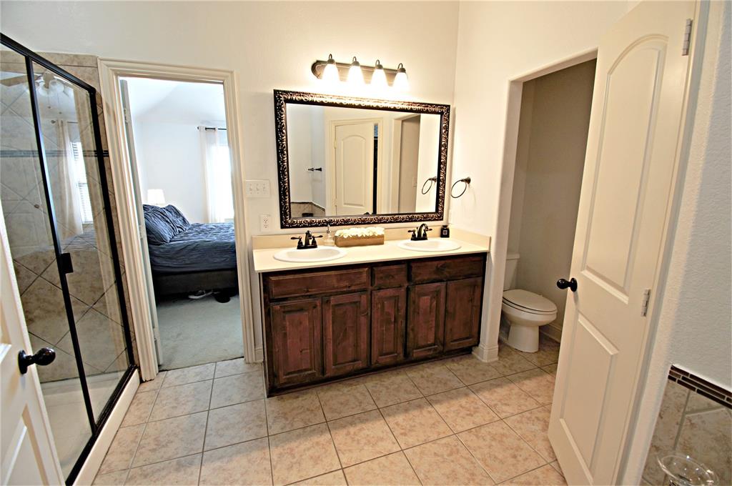 3702 Dogwood Road Melissa, TX 75454 - Photo 16 of 24 a en suite bathroom with a double vanity sink and a mirror