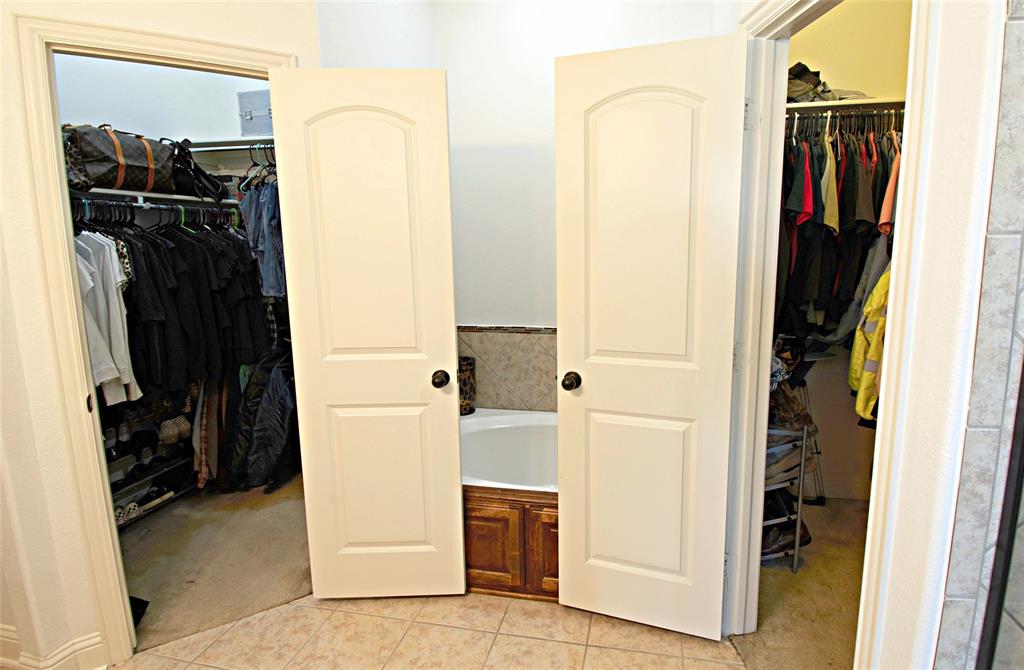3702 Dogwood Road Melissa, TX 75454 - Photo 18 of 24 a view of walk in closet with clothes and shoes