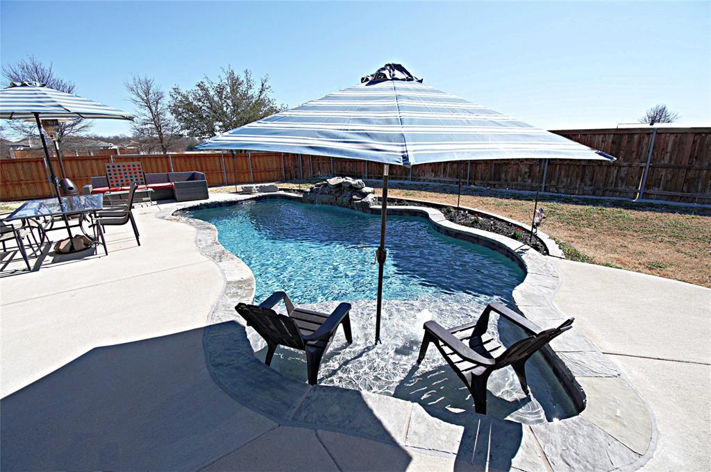 3702 Dogwood Road Melissa, TX 75454 - Photo 22 of 24 a view of a patio with table and chairs under an umbrella