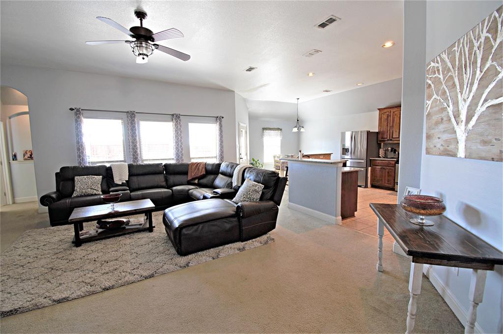 3702 Dogwood Road Melissa, TX 75454 - Photo 3 of 24 a living room with a couch and a chandelier