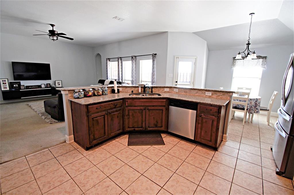 3702 Dogwood Road Melissa, TX 75454 - Photo 8 of 24 a kitchen with stainless steel appliances granite countertop a sink and a stove