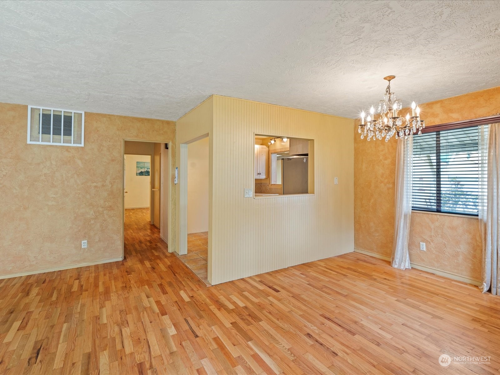 16446 Southeast Jones Road Renton, WA 98058 - Photo 11 of 40 a bedroom with a bed and a chandelier