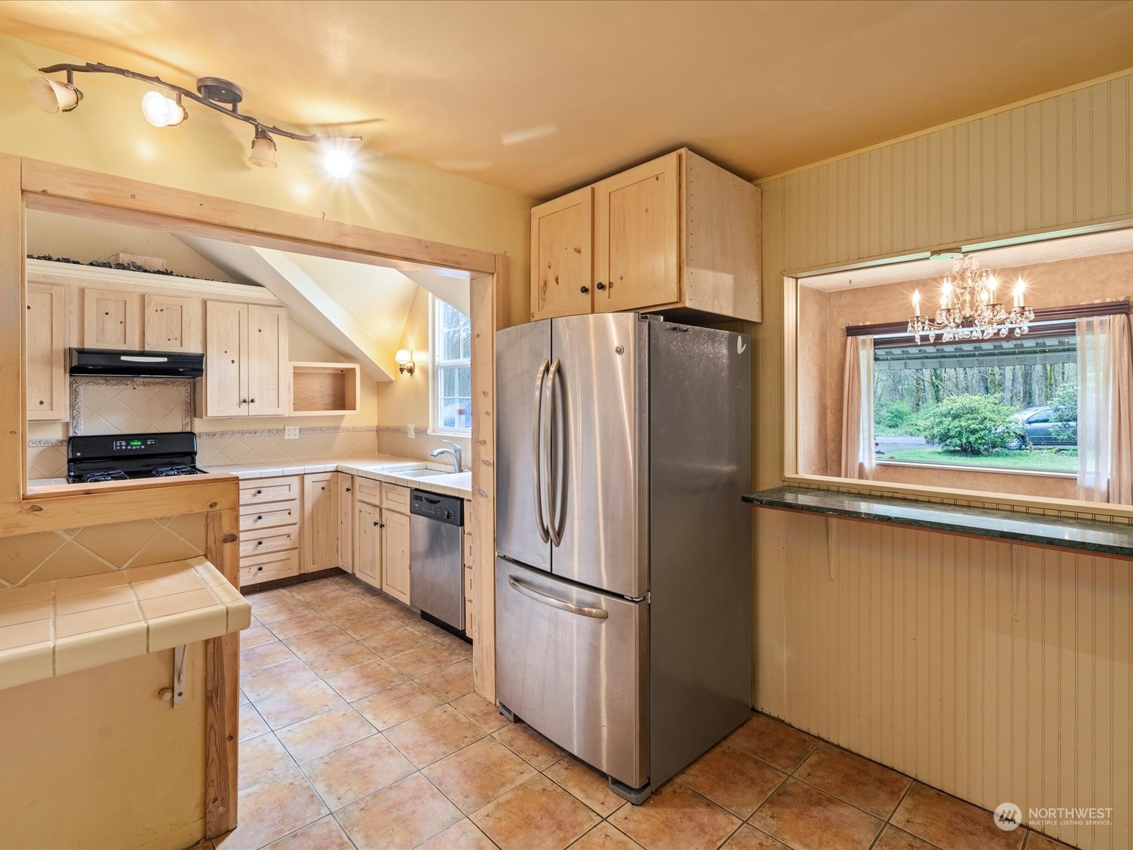 16446 Southeast Jones Road Renton, WA 98058 - Photo 15 of 40 a kitchen with a refrigerator sink and cabinets