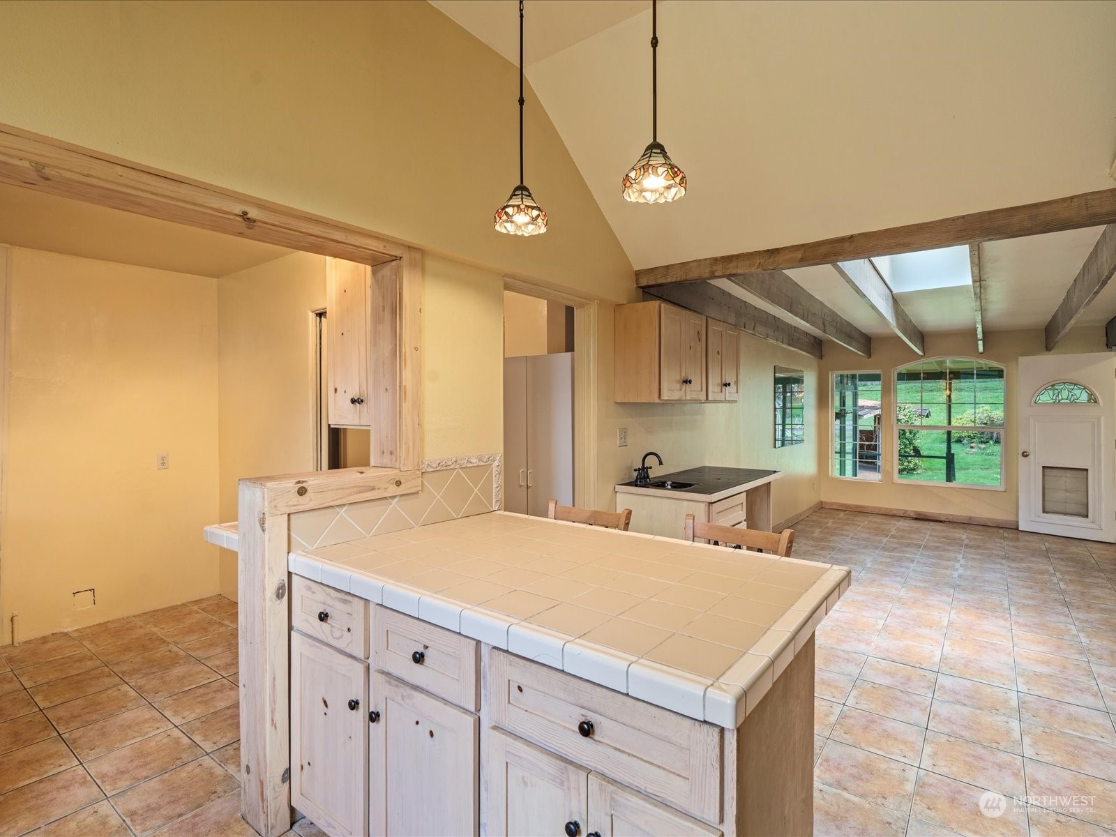 16446 Southeast Jones Road Renton, WA 98058 - Photo 19 of 40 a view of a kitchen with a sink a counter space and a window