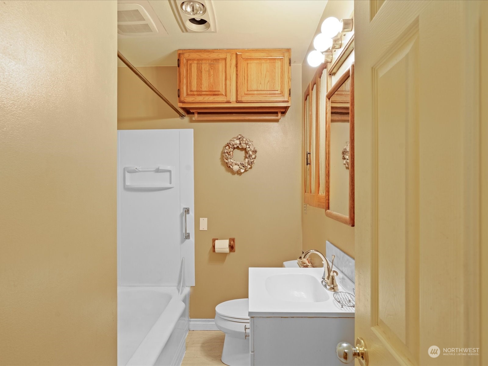 16446 Southeast Jones Road Renton, WA 98058 - Photo 25 of 40 a bathroom with a sink a toilet and shower curtain