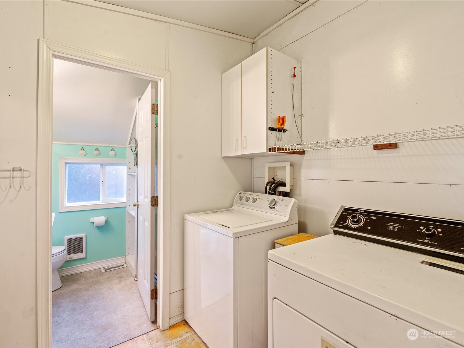 16446 Southeast Jones Road Renton, WA 98058 - Photo 31 of 40 a view of storage and utility room with washer and dryer