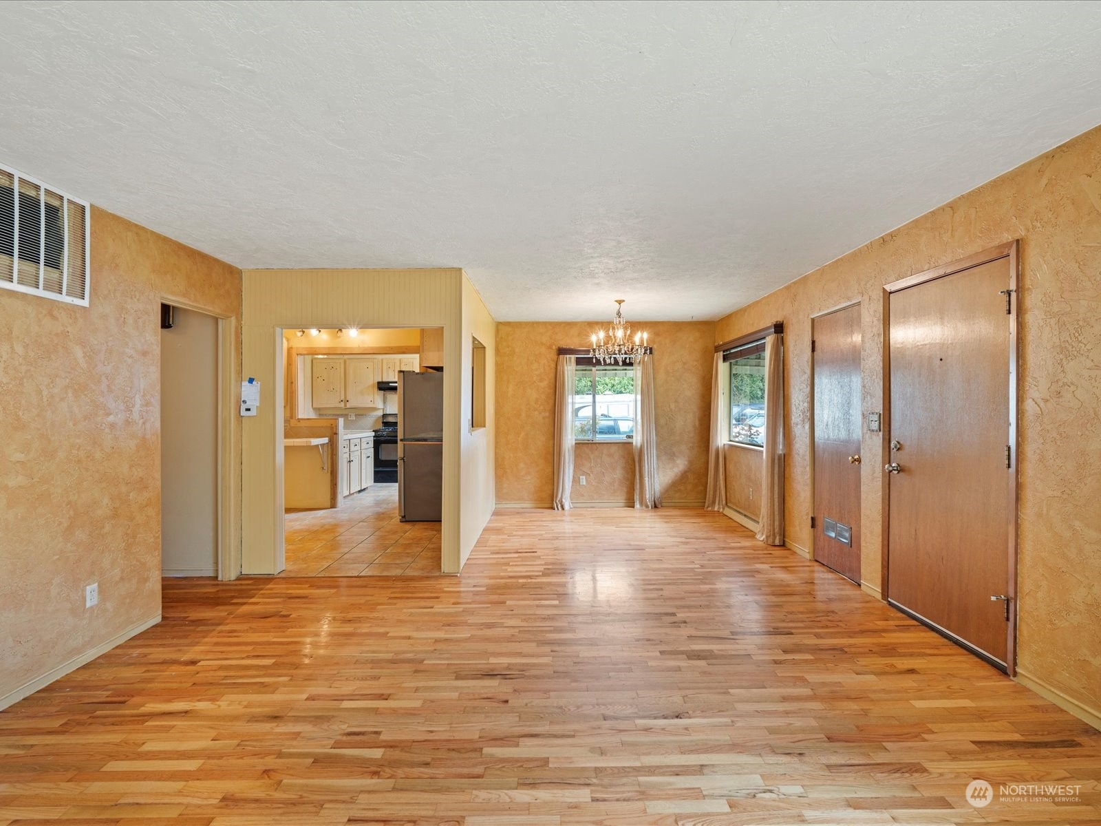 16446 Southeast Jones Road Renton, WA 98058 - Photo 7 of 40 a view of a hallway with wooden floor and a bathroom