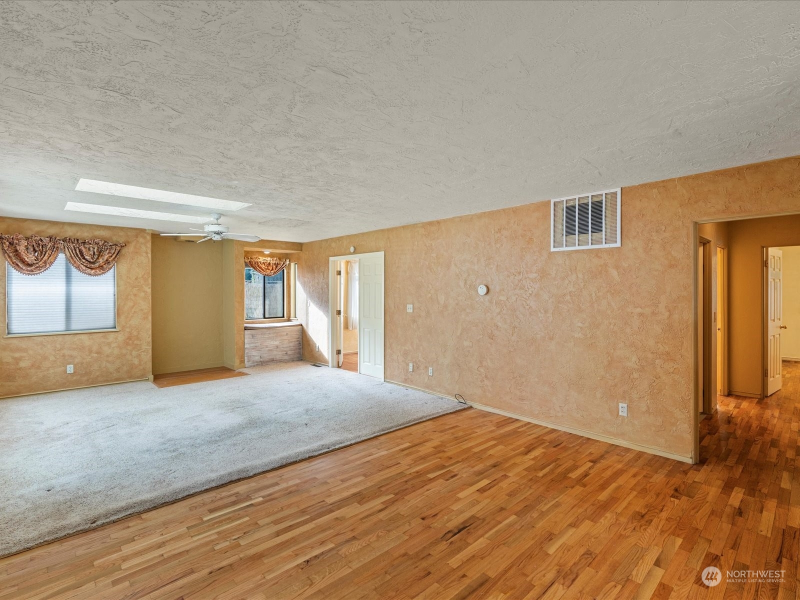 16446 Southeast Jones Road Renton, WA 98058 - Photo 10 of 40 a view of an empty room with wooden floor and a window