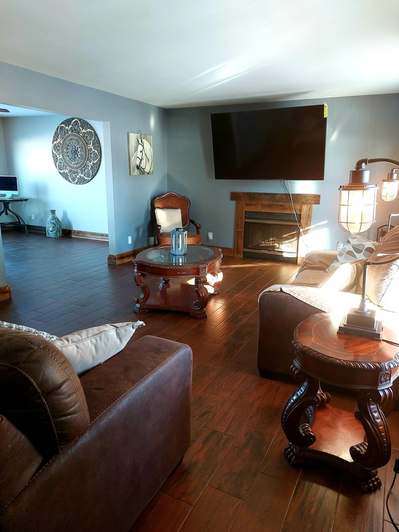 44-w046 Rohrsen Road Hampshire, IL 60140 - Photo 16 of 34 a living room with furniture a flat screen tv and a fireplace
