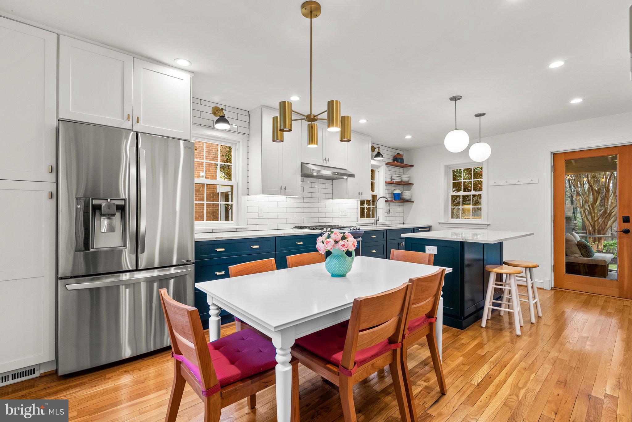 10115 Big Rock Road Silver Spring, MD 20901 - Photo 16 of 43 a kitchen with stainless steel appliances granite countertop a dining table and chairs