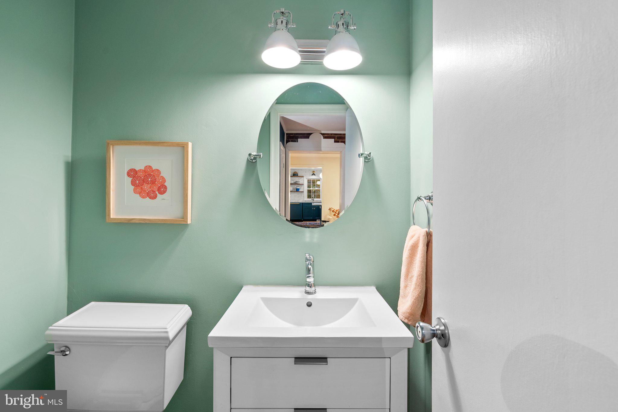 10115 Big Rock Road Silver Spring, MD 20901 - Photo 21 of 43 a bathroom with a toilet sink and mirror