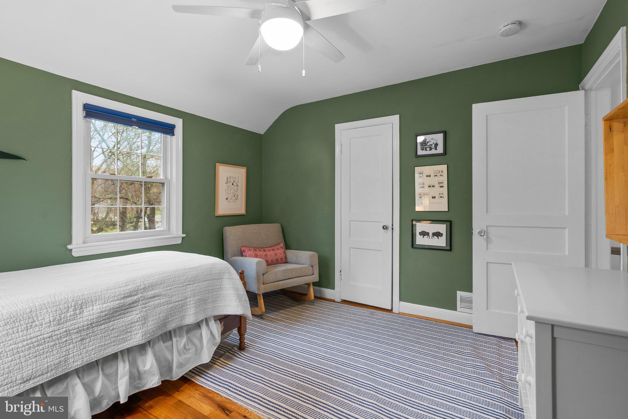 10115 Big Rock Road Silver Spring, MD 20901 - Photo 31 of 43 a bedroom with a bed and wooden floor