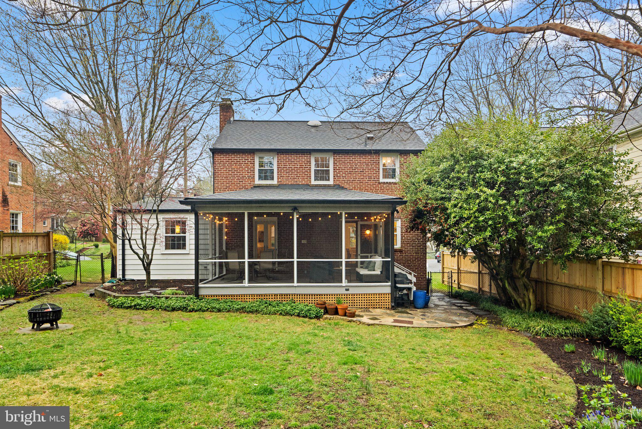 10115 Big Rock Road Silver Spring, MD 20901 - Photo 35 of 43 a view of a brick house with a large window and large trees